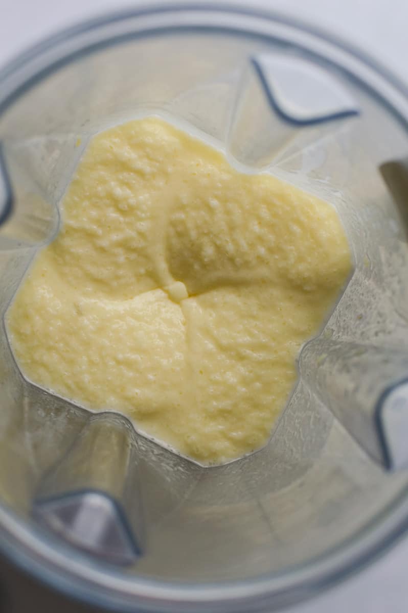 Blending frozen pineapple and ice.