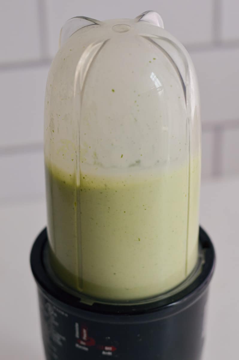 Blending Greek yogurt, cilantro, feta and lime for a salad dressing.