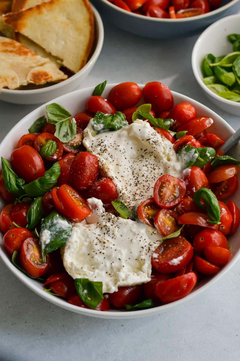 Burrata caprese salad served with pita.