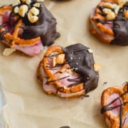 Chocolate covered strawberry yogurt pretzels on a tray.