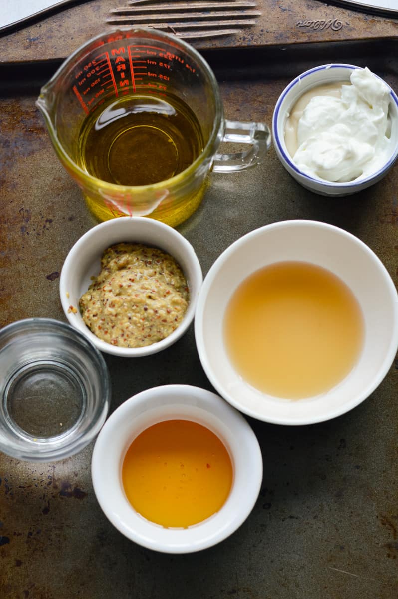 Dressing ingredients including greek yogurt, mustard, honey, olive oil, and water.