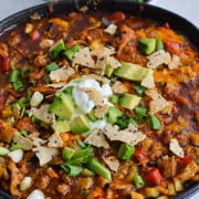 Lazy enchilada skillet topped with green onions, avocado and Greek yogurt.