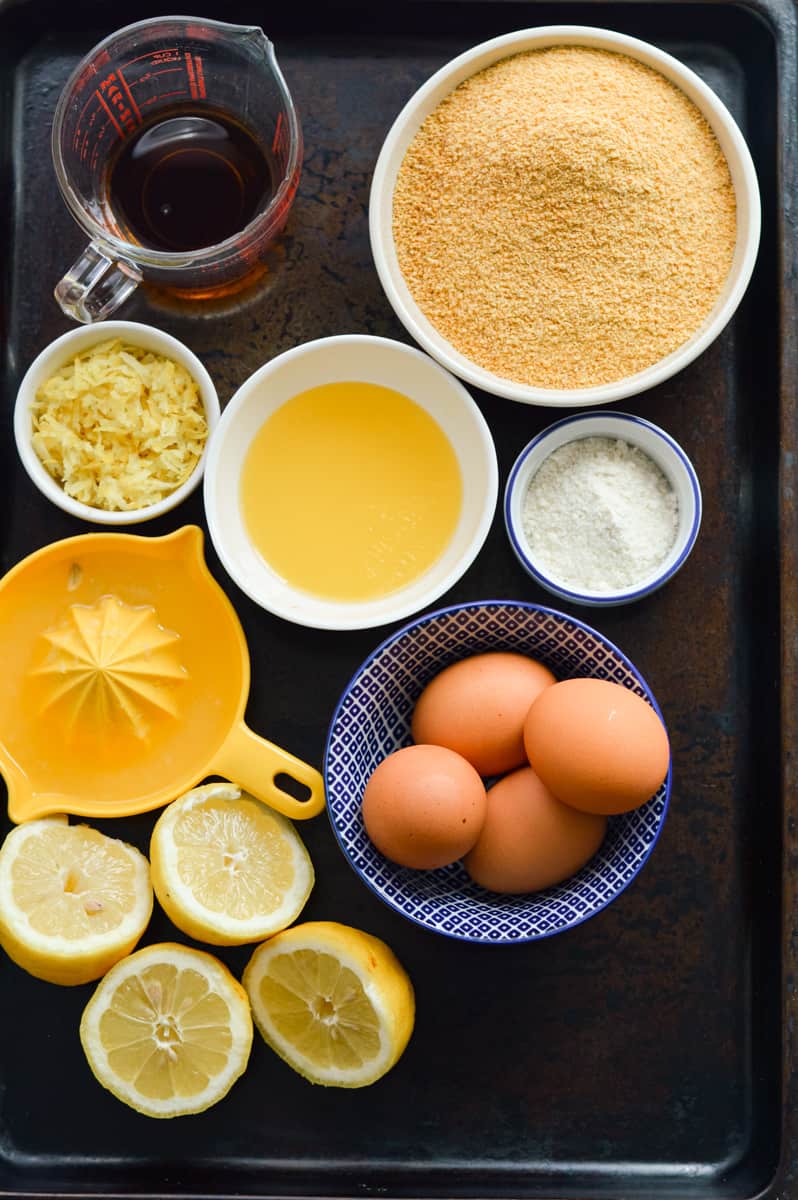 Lemon bar ingredients including eggs, coconut flour, lemons, and maple syrup.