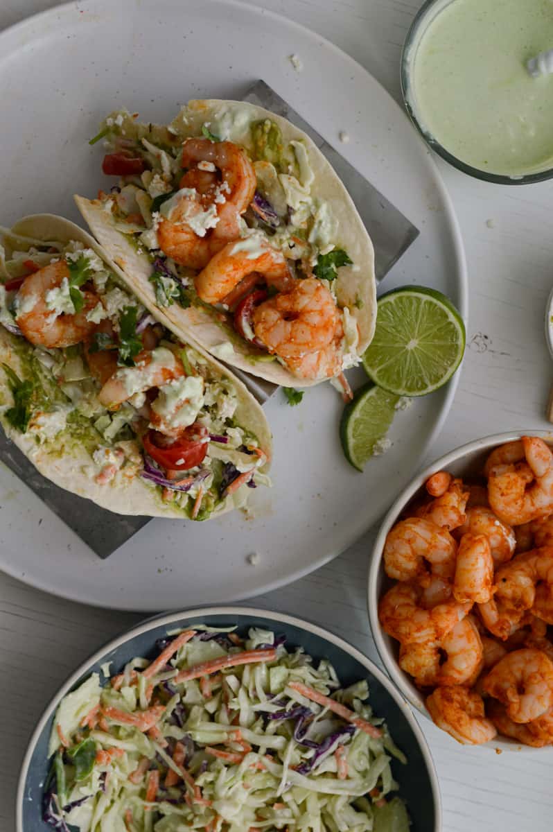 Serving air fryer shrimp tacos with cilantro lime dressing.