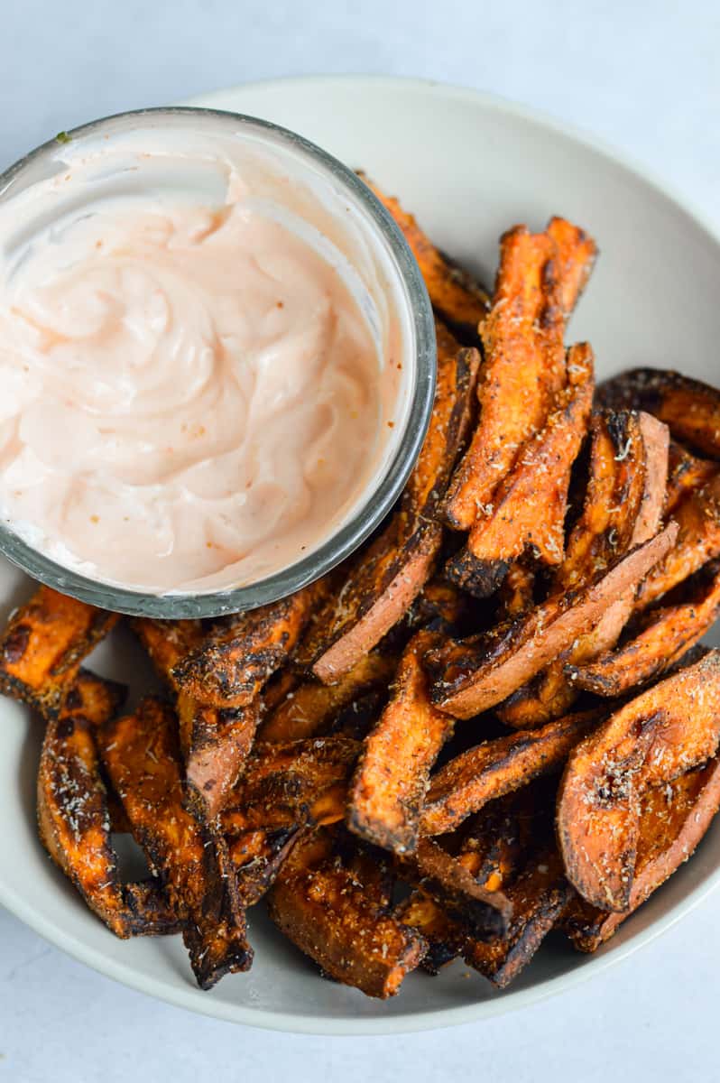 Air fryer sweet potato wedges served with homemade sriracha dip.