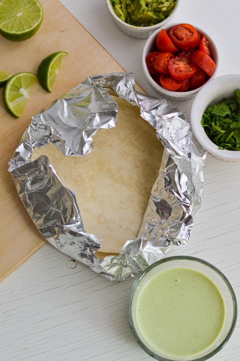 Warming tortillas in tin foil.