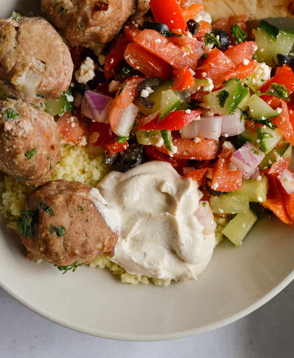 Tahini yogurt sauce on mediterranean bowls.