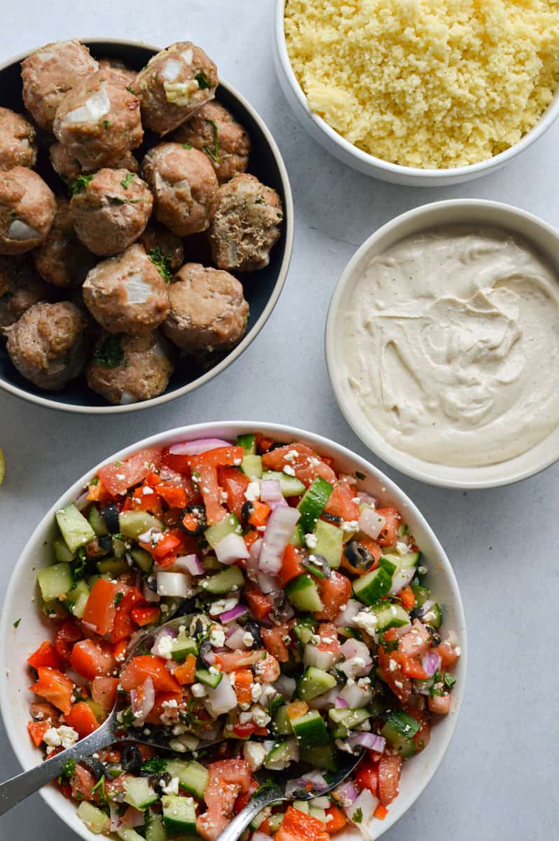 Assembling Mediterranean grain bowls.