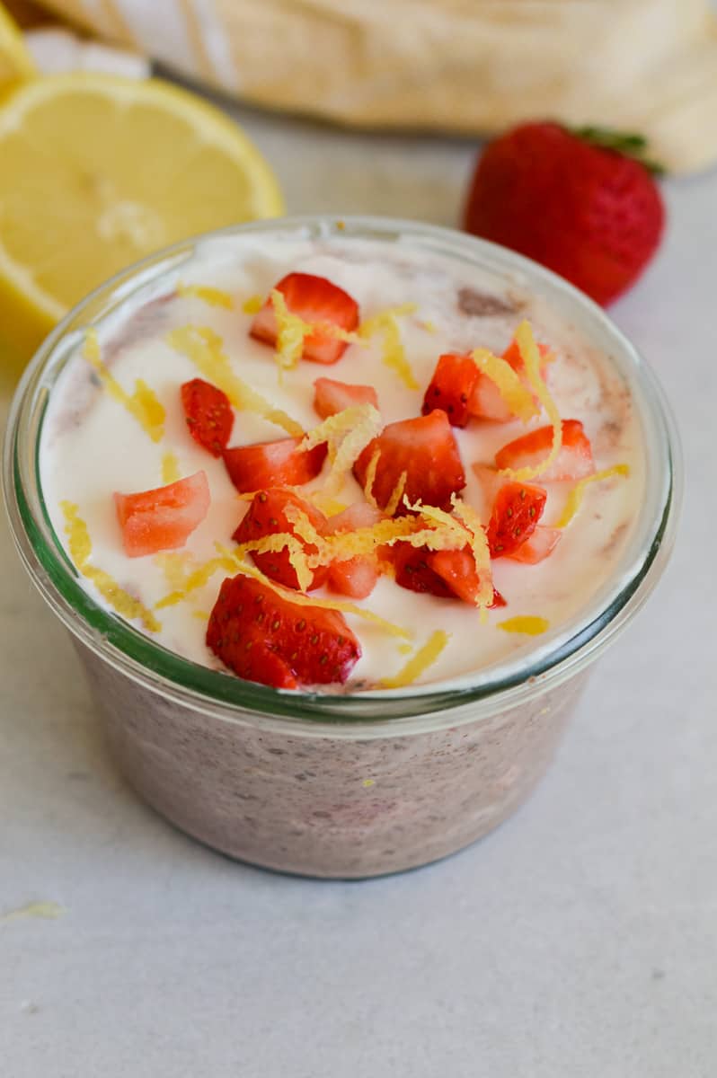 Close up of strawberry lemonade blended chia pudding with yogurt, strawberries and lemon zest.