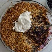 Birds eye of gluten free blueberry crisp with vanilla ice cream.