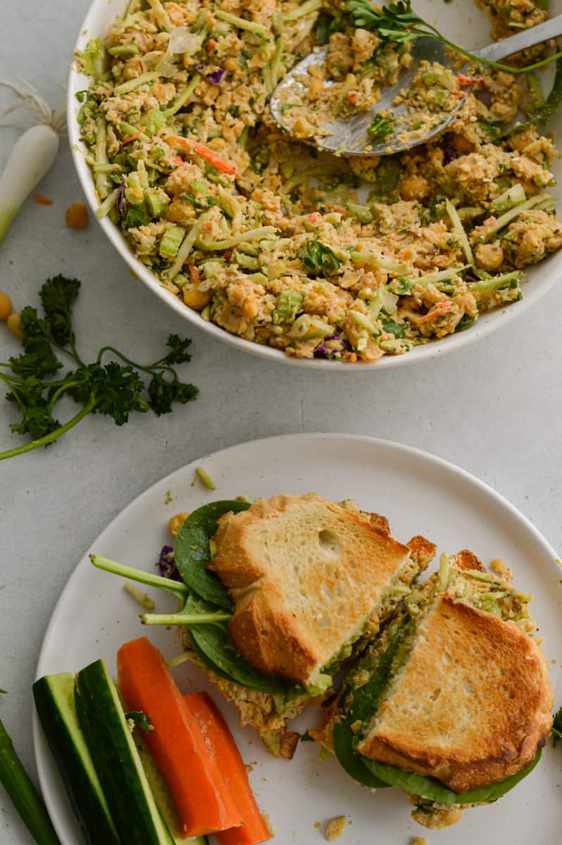 Making a sandwich with vegan chickpea salad.