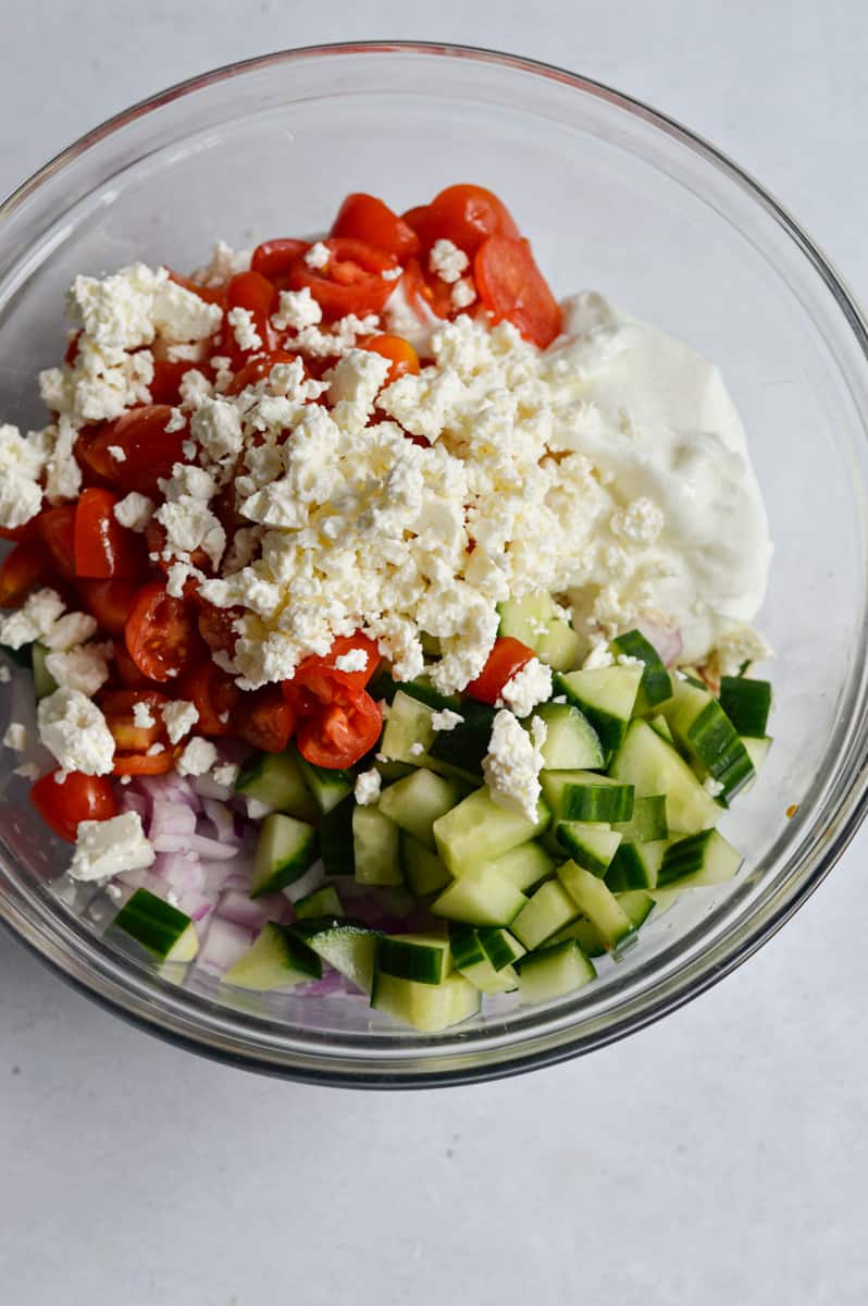 Mixing ingredients for tzatziki salad.