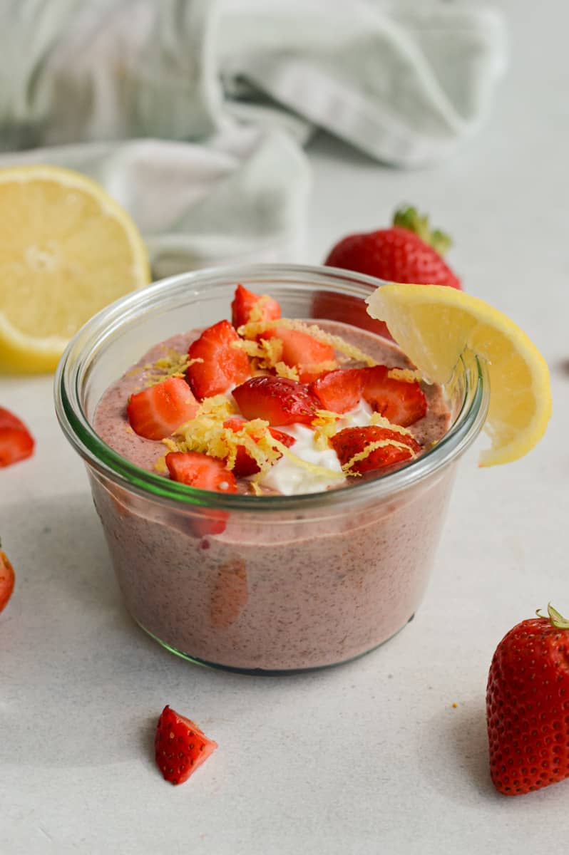 Strawberry lemonade blended chia pudding topped with strawberries, yogurt and a lemon slice.
