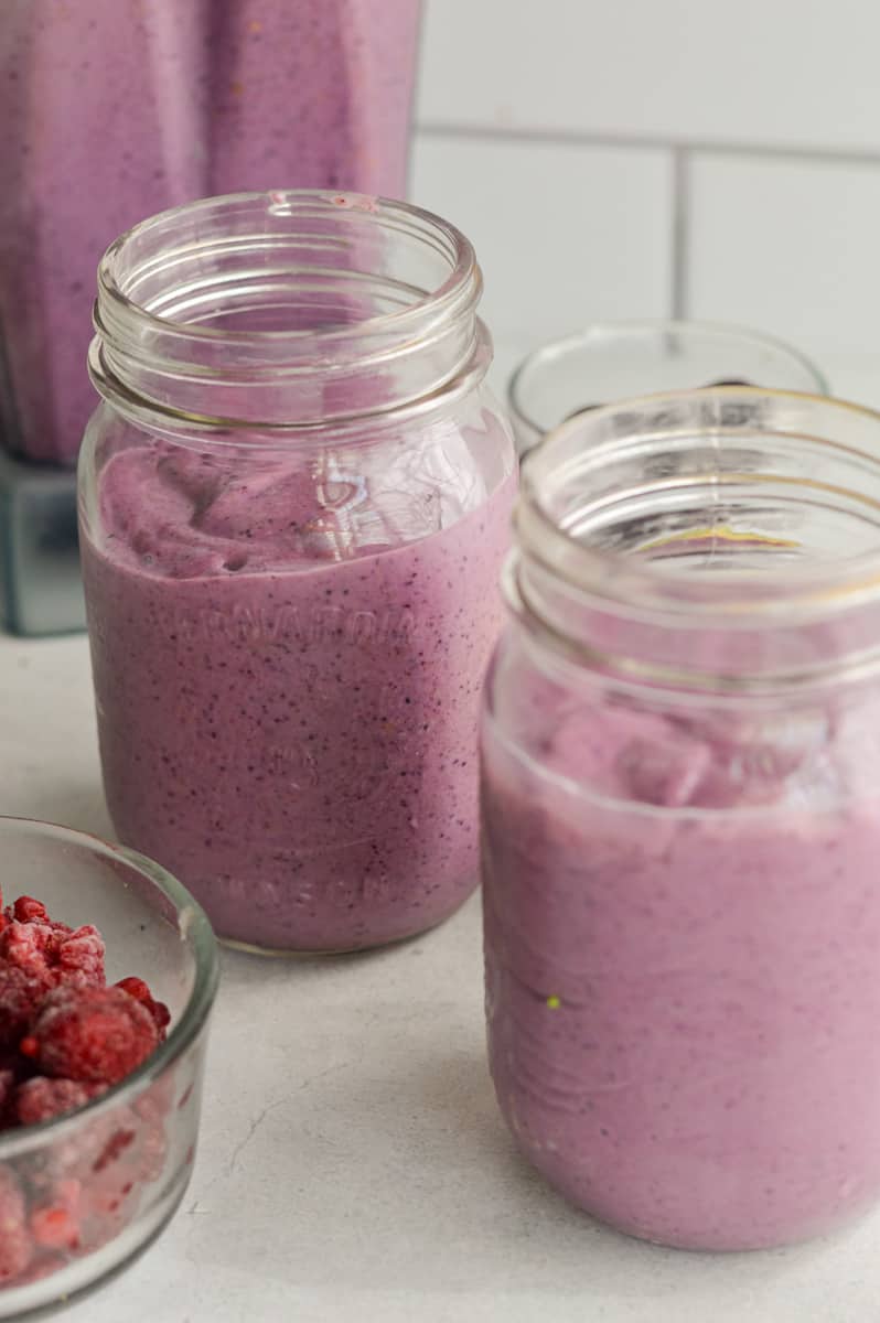 Two jars with high fiber berry smoothies.