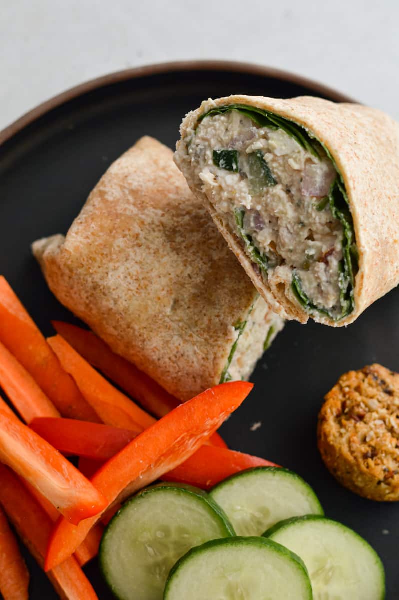 Tzatziki salad wrap served with peppers and cucumbers.