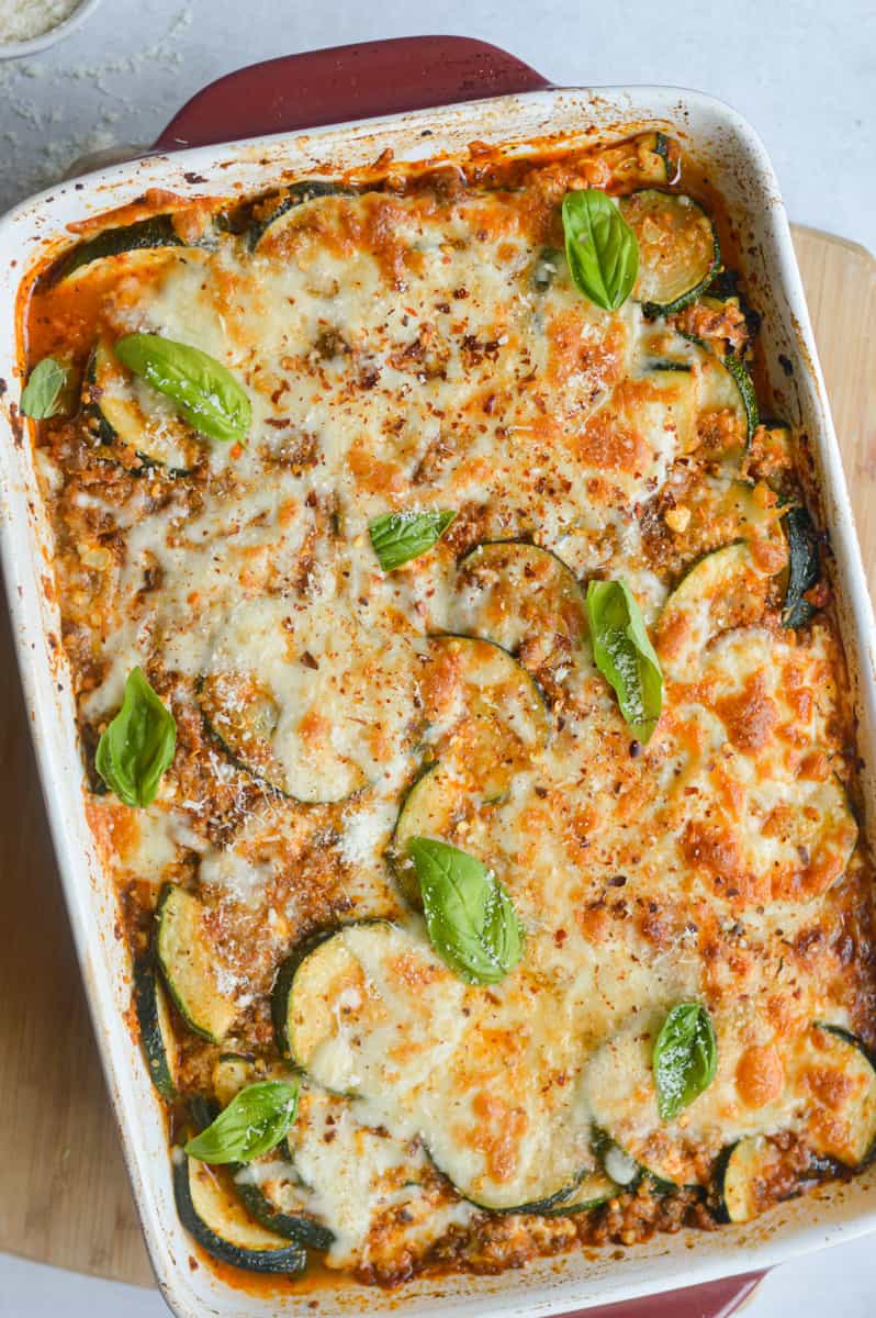 Birds eye of ground beef zucchini casserole topped with cheese and fresh basil.