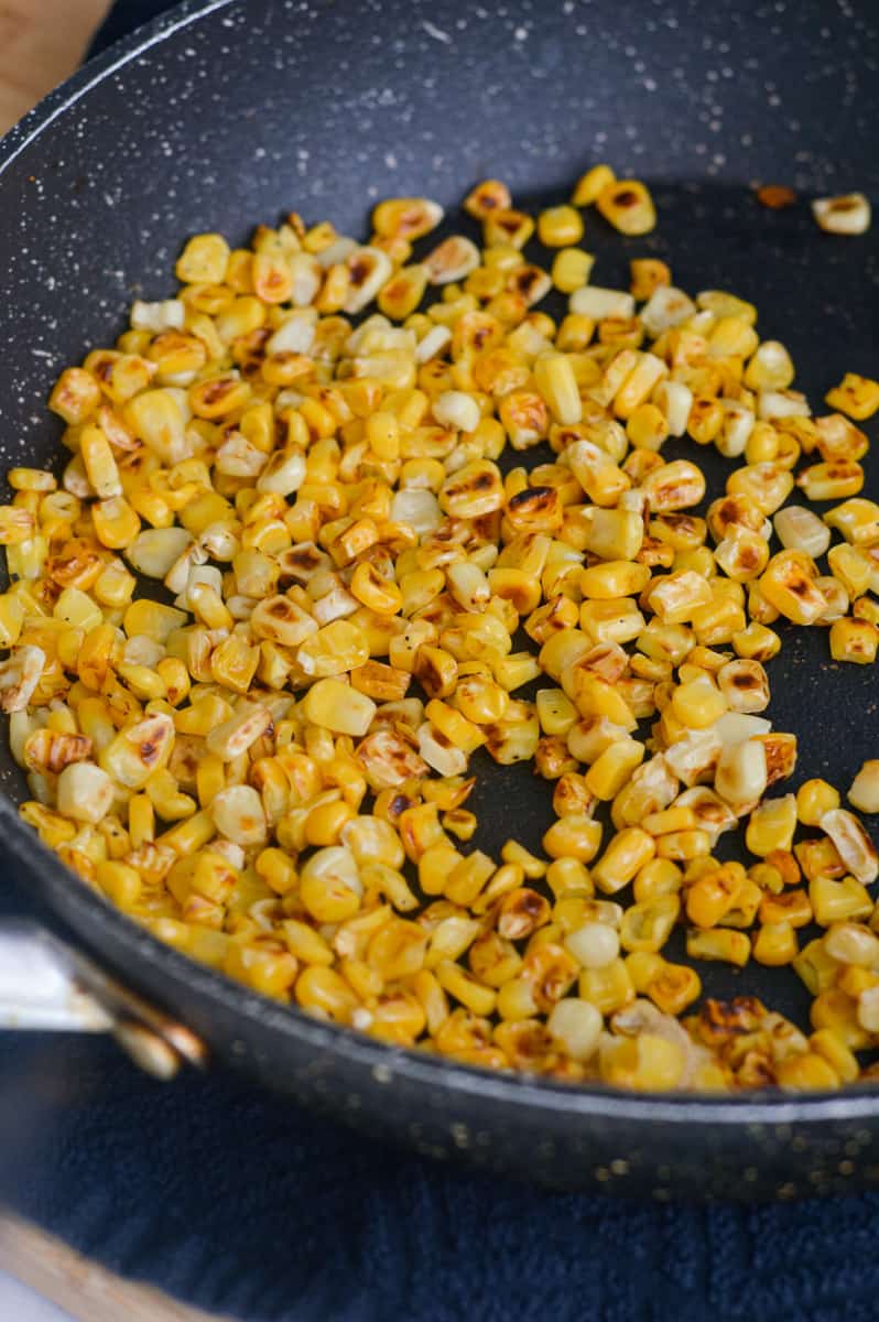 Cooking corn kernels in a pan.