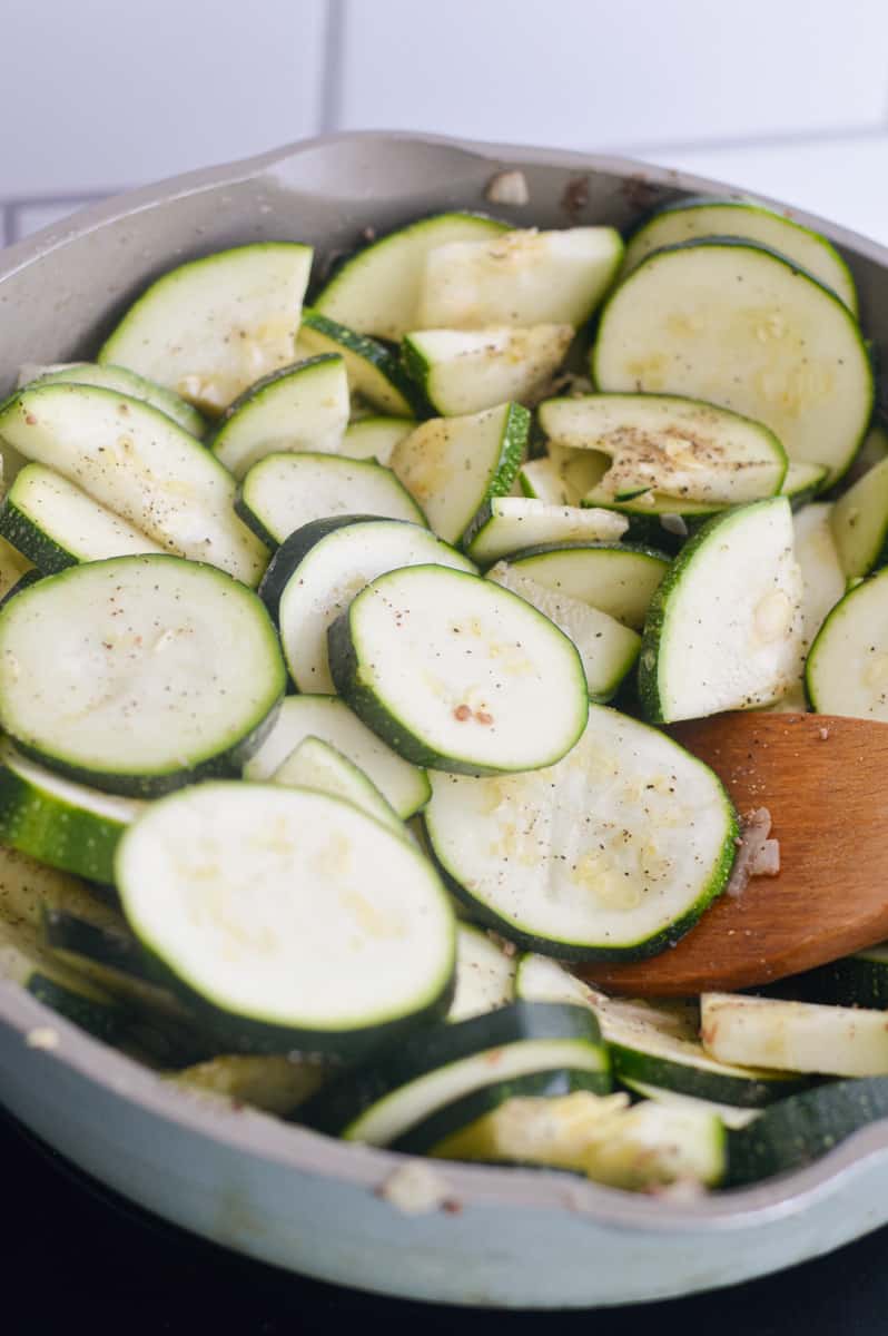 Sauteeing zucchini in a pan.
