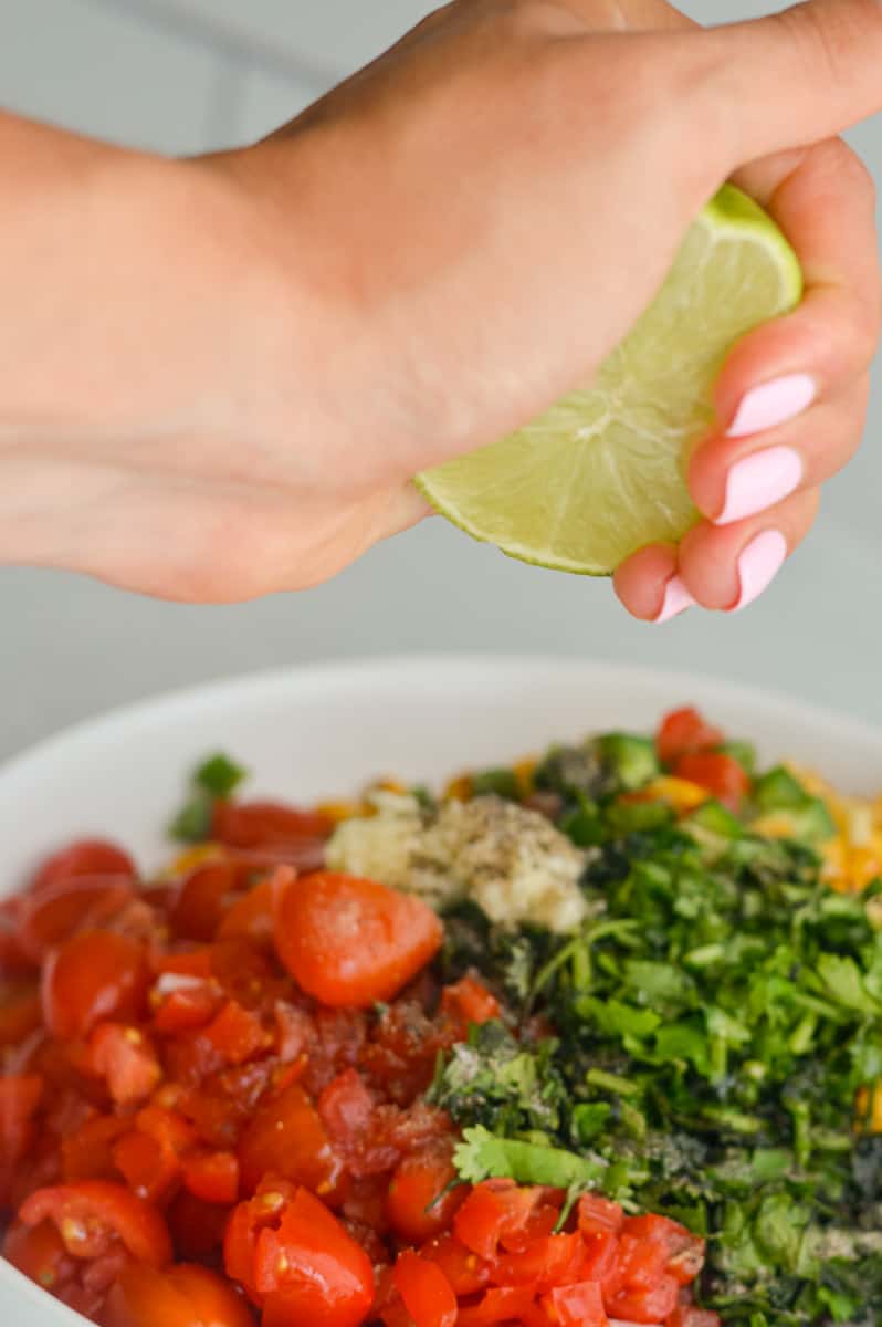 Squeezing lime juice on mango corn salsa.