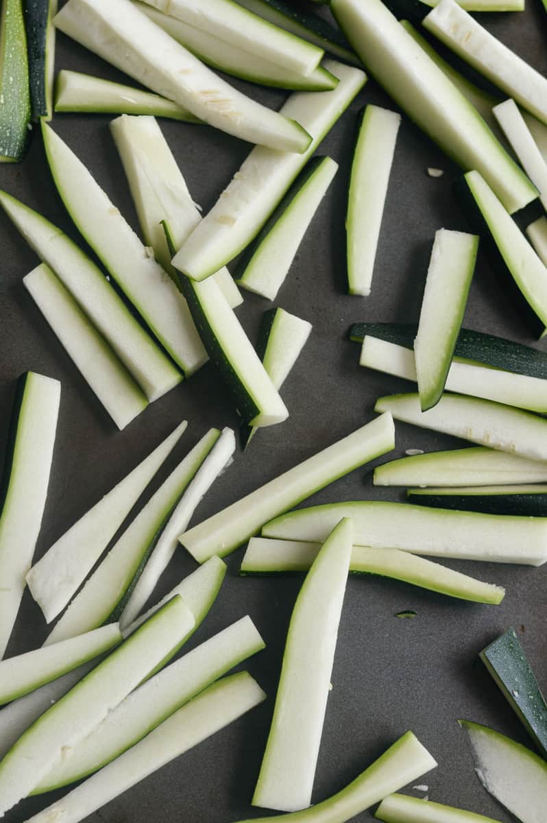 Cutting zucchini into fry shapes.