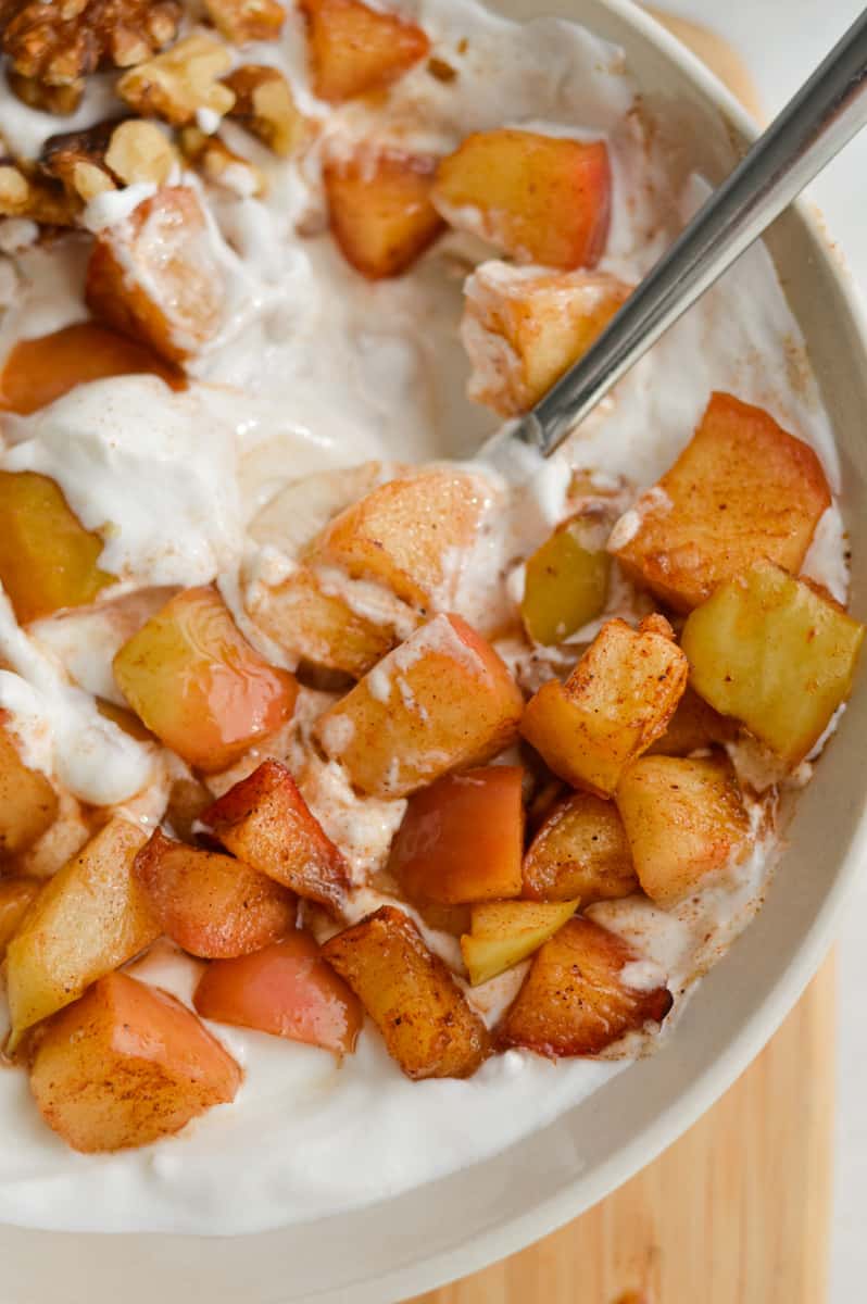 Close up of cinnamon air fryer apples in yogurt bowl.