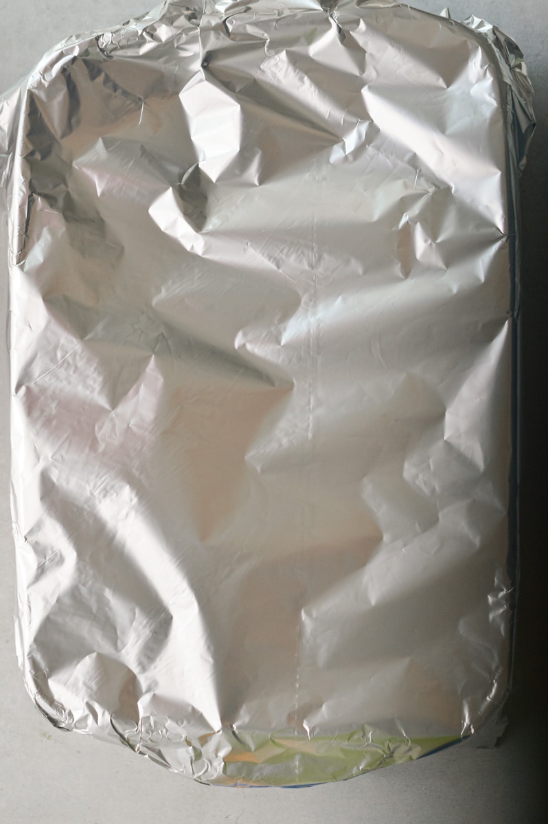 Covering pasta bake with tin foil.