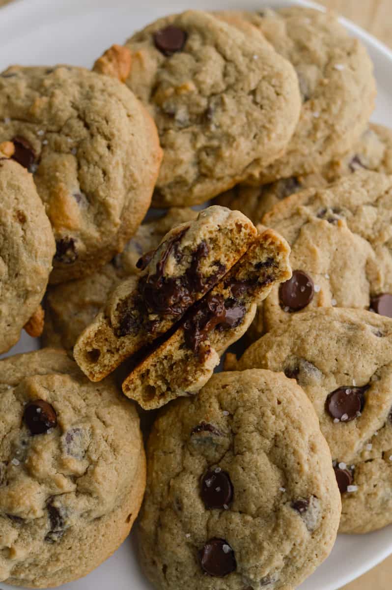 Plate of oat flour chocolate chip cookies, with the centre cookie cut in half.