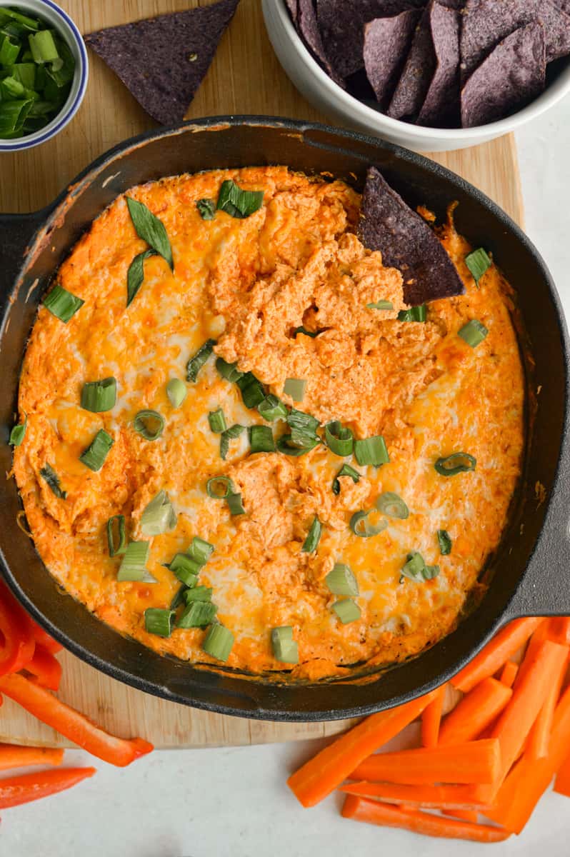 Birds eye of buffalo chicken dip with greek yogurt, served with carrot sticks and tortilla chips.
