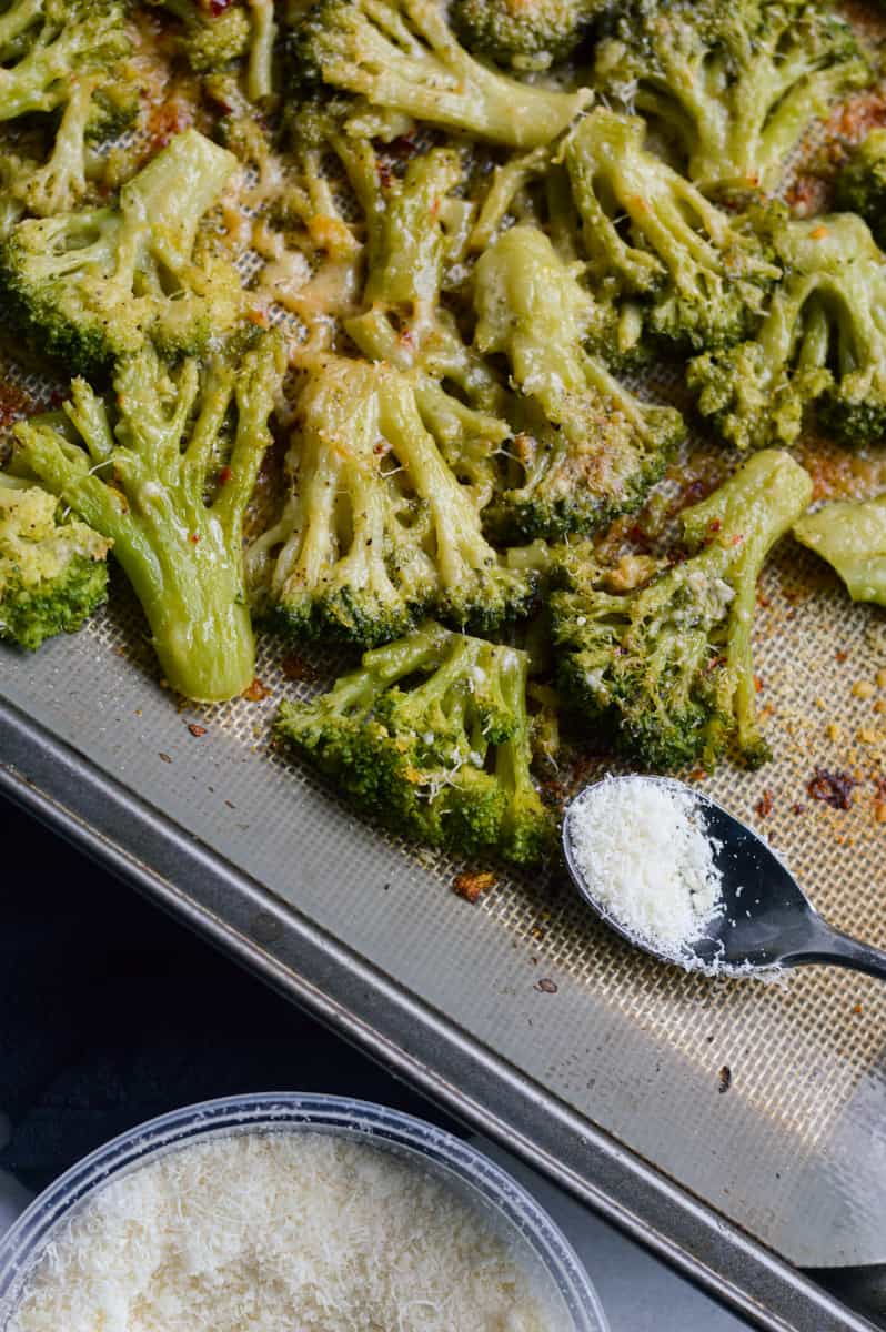 Lemon parmesan smashed broccoli on a tray.