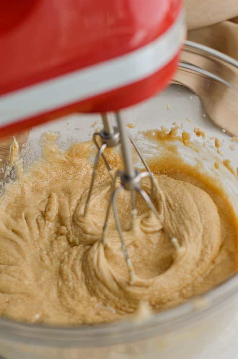 Creaming butter and sugar with an electric mixer.