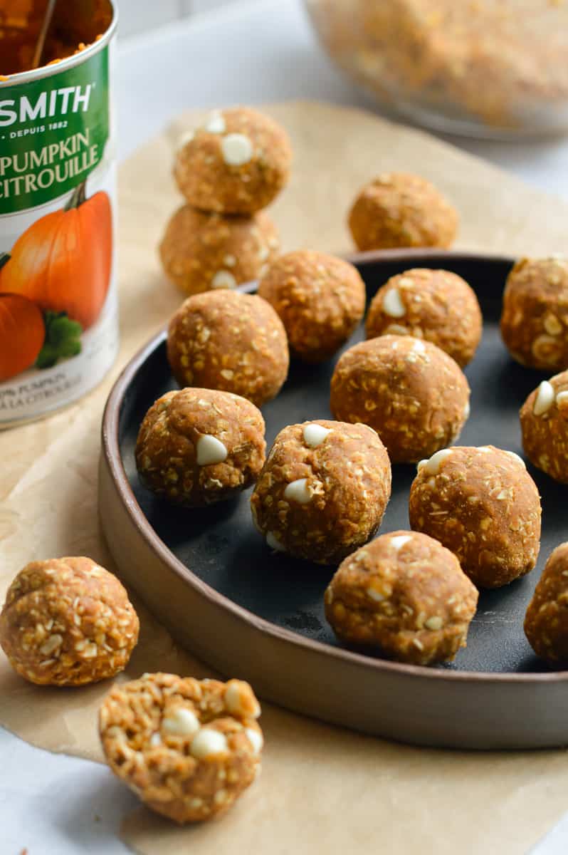 Plate of pumpkin protein balls next to a can of pumpkin puree.