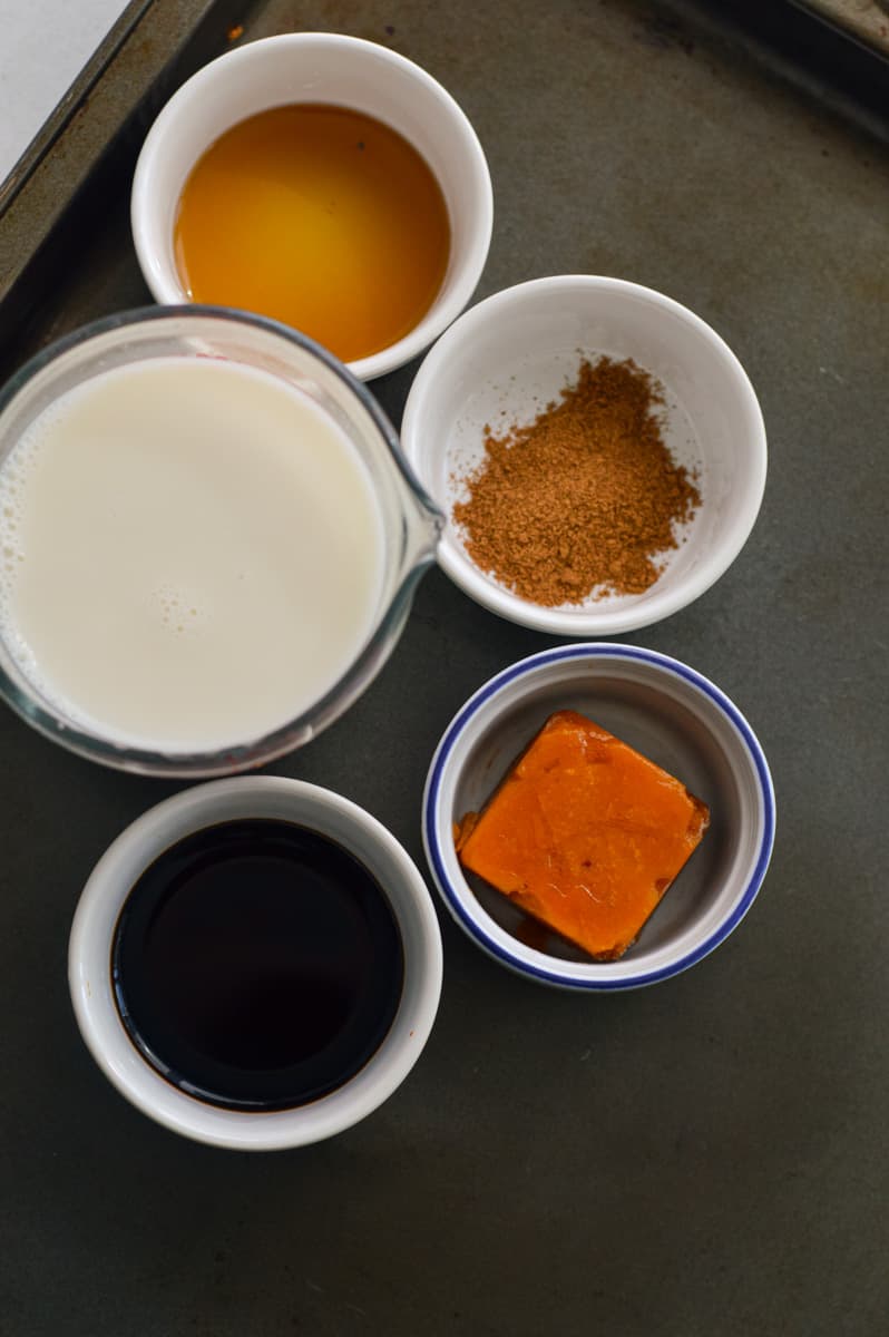 Ingredients including pumpkin puree, maple syrup, pumpkin pie spice, milk and cold brew.