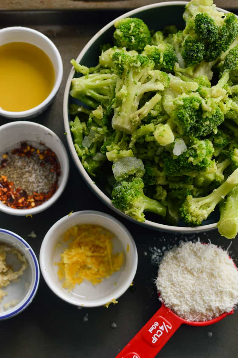 Ingredients including broccoli, parmesan, lemon zest, spices, garlic and olive oil.