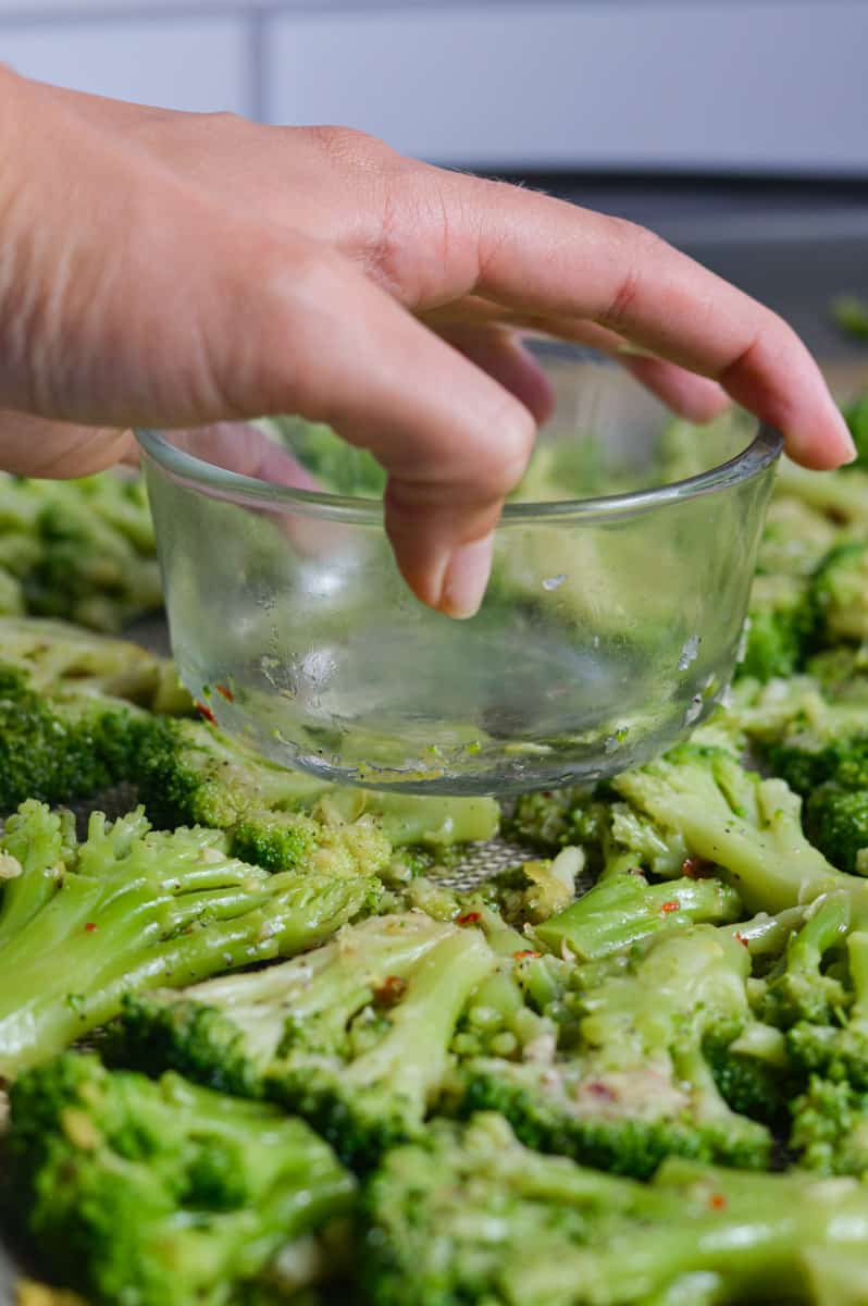 Smashing broccoli with a glass bowl.