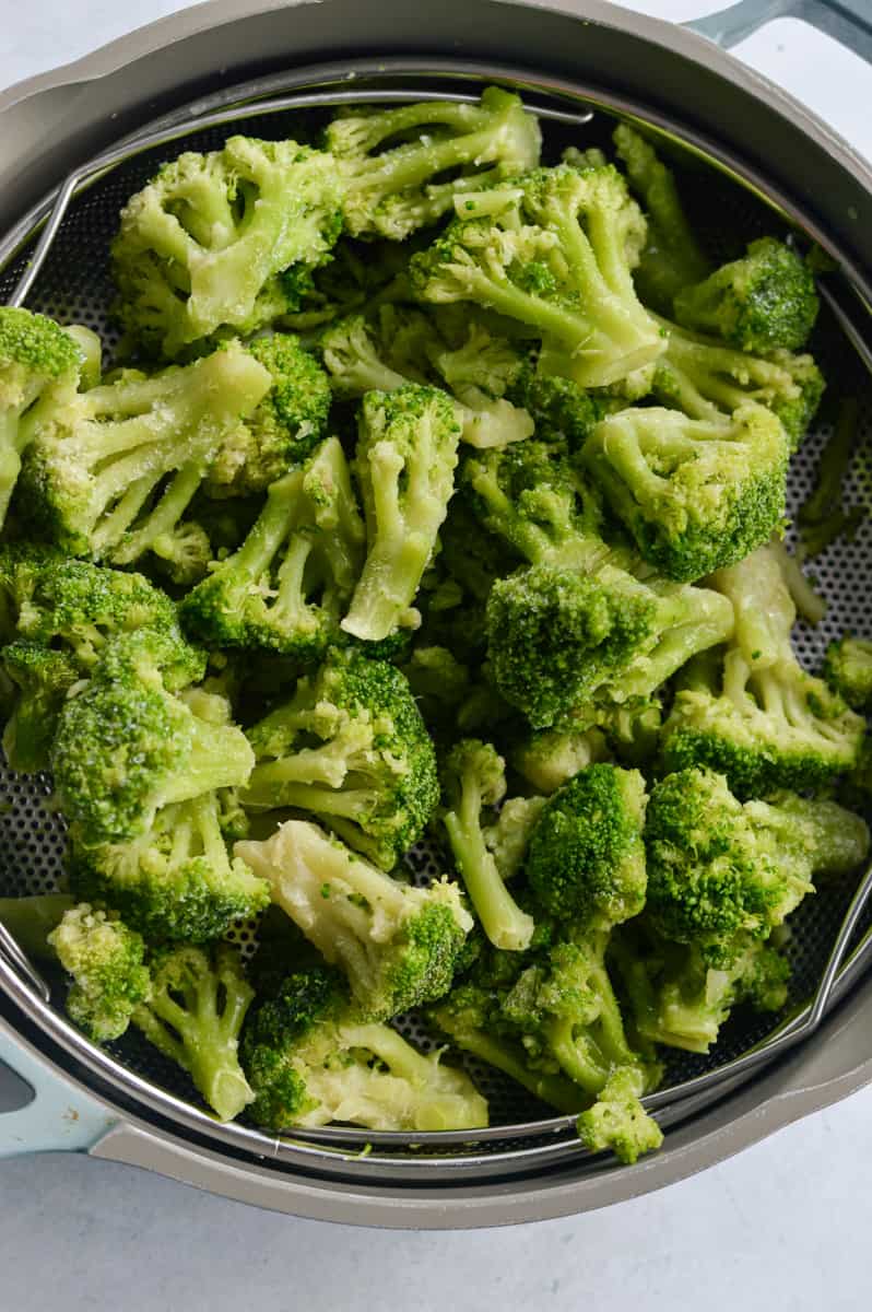 Steaming broccoli in a pot.