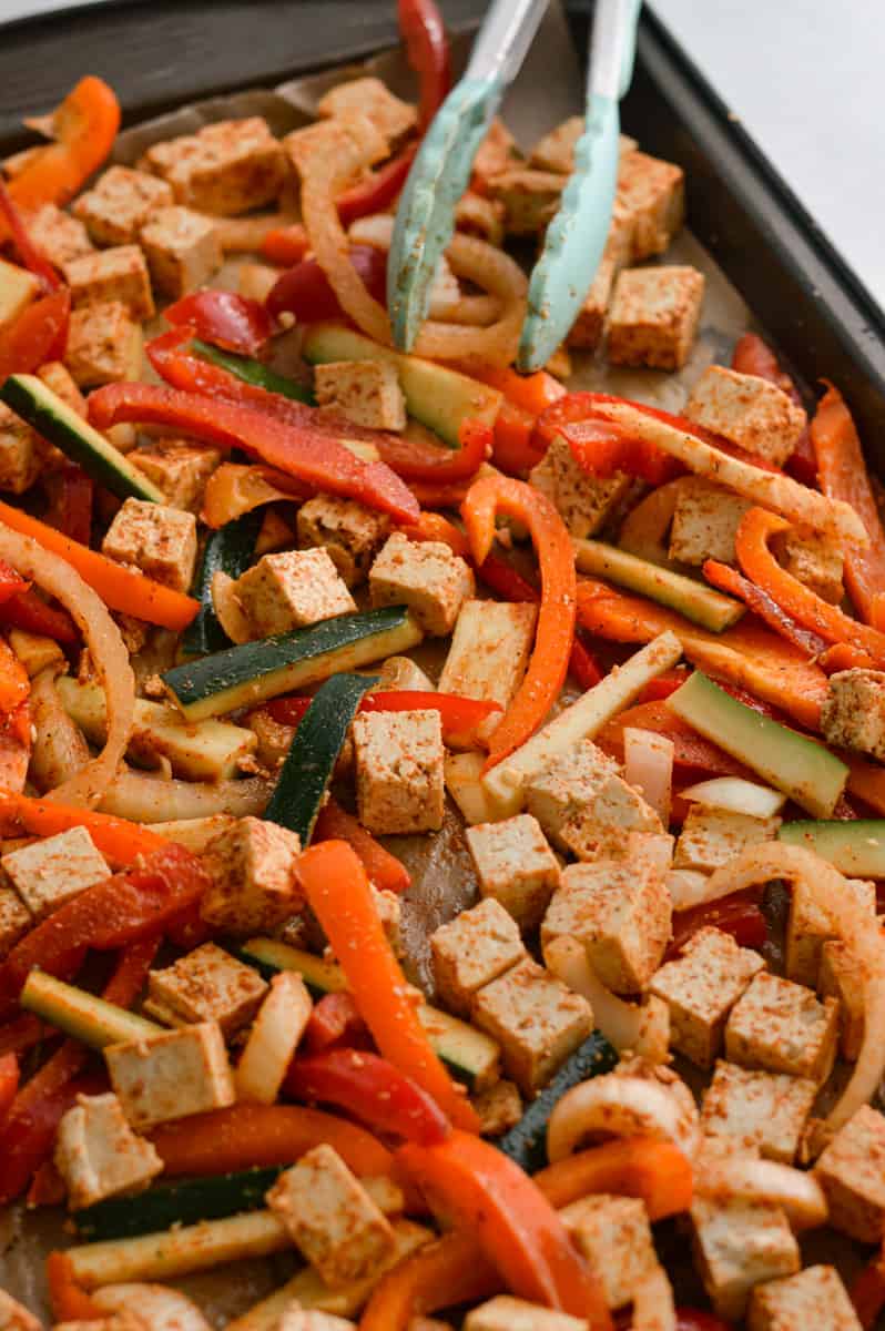 Tossing ingredients with fajita seasoning.