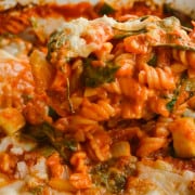 Scooping vegan pasta bake.