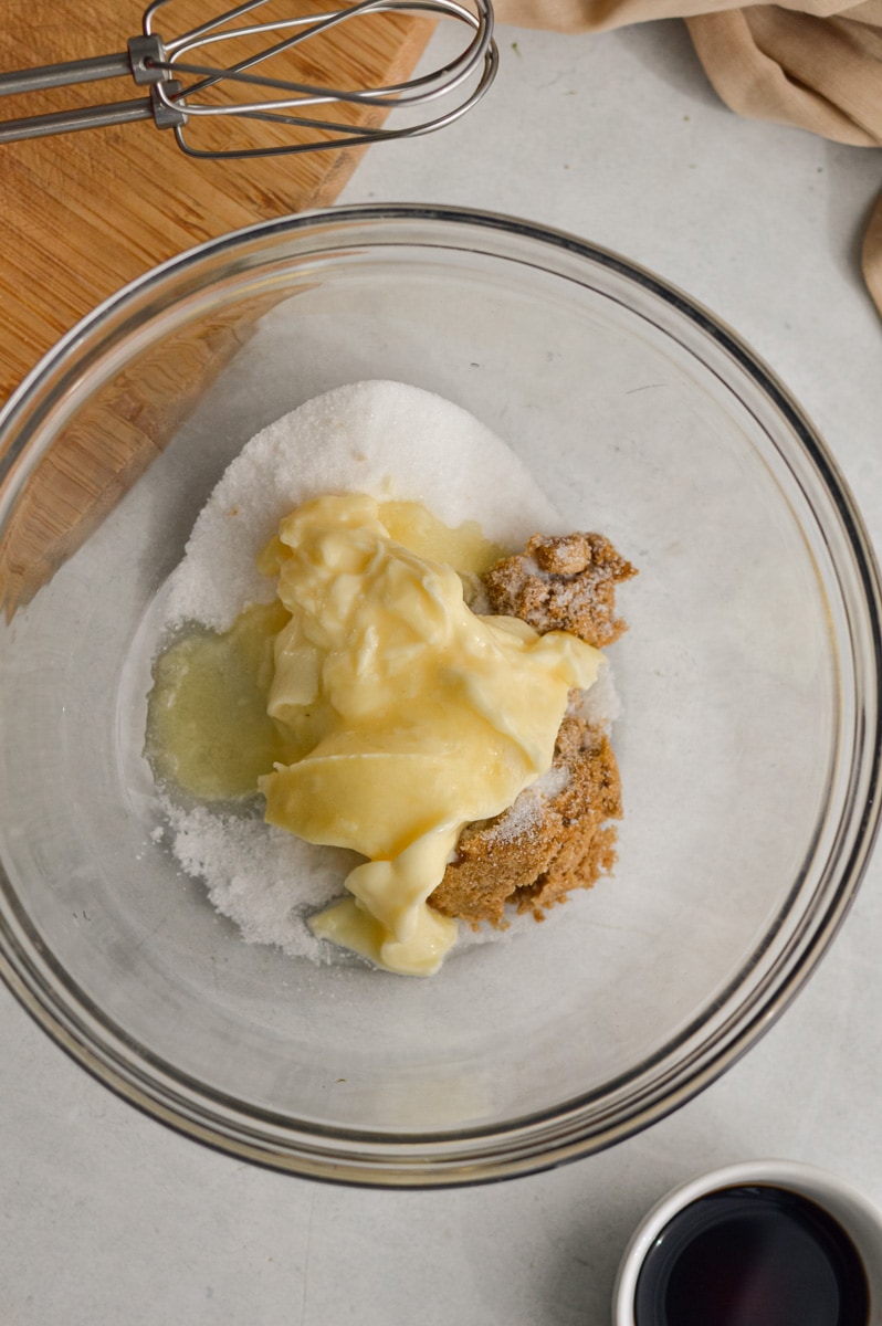 Adding butter and sugar to a bowl.