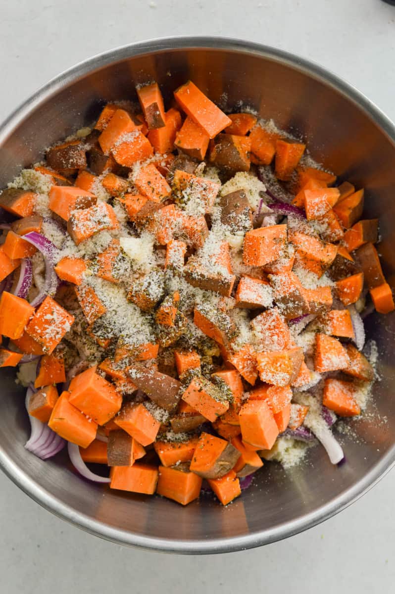 Seasoning sweet potato, cauliflower and brussel sprouts.