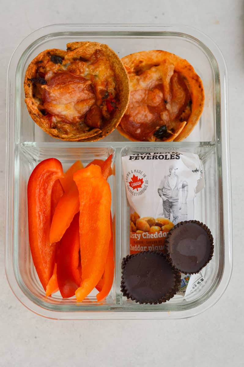 Adult lunchable with pizza cups, bell peppers, chocolate and crispy fava beans.