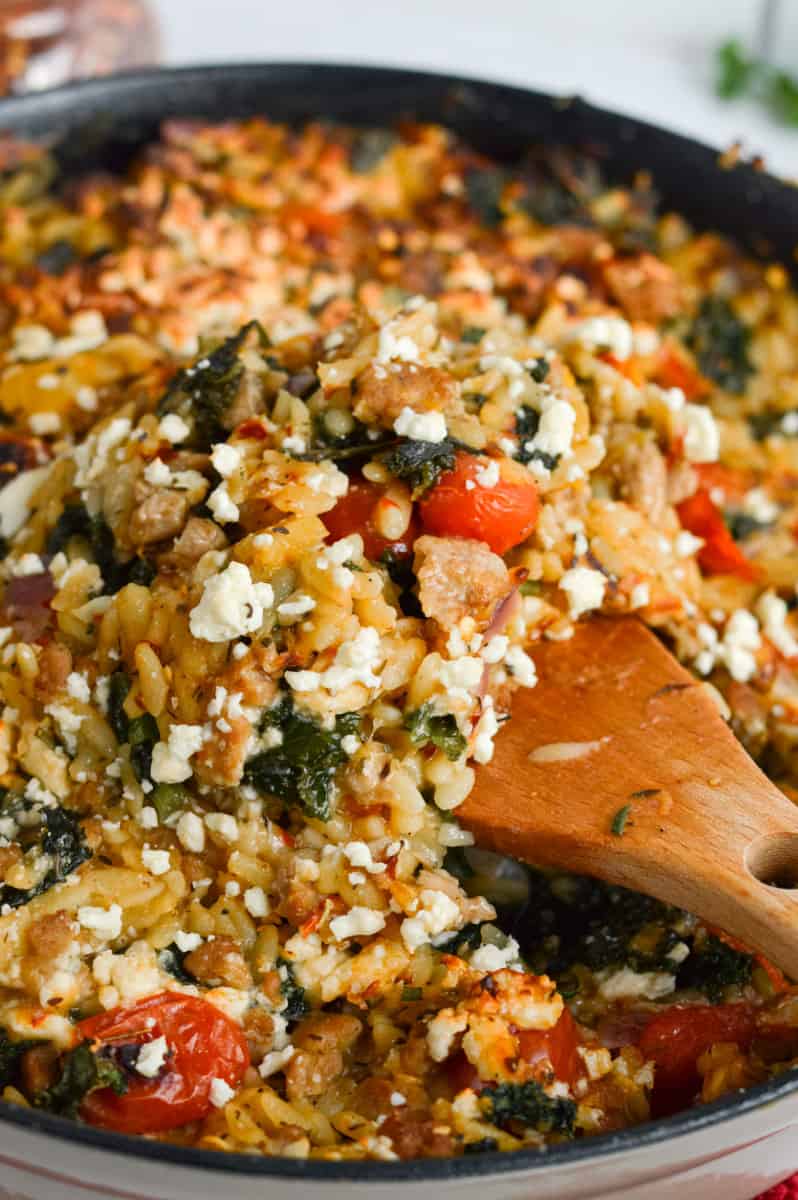One pan meal of butternut squash orzo with sausage and kale.