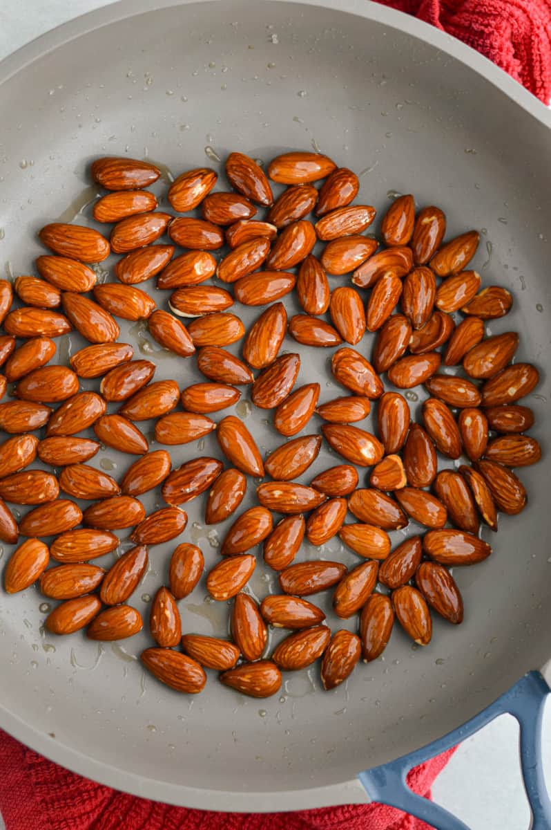 Toasting almonds in a pan.