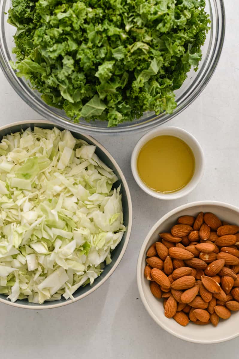 Ingredients including kale, cabbage, almonds and olive oil.