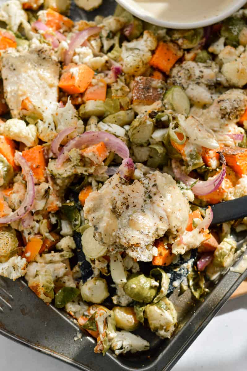 Parmesan chicken thighs and veggies on a sheet pan.
