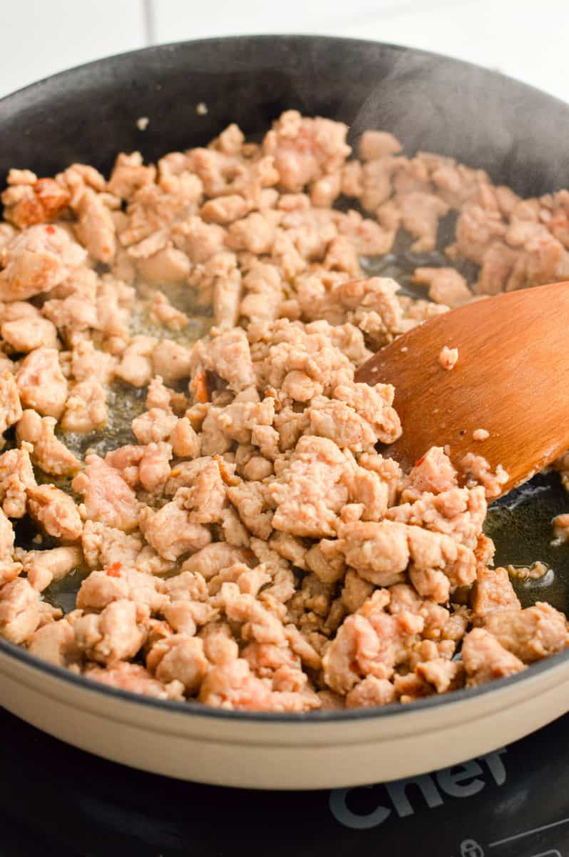 Cooking turkey sausage in a pan.