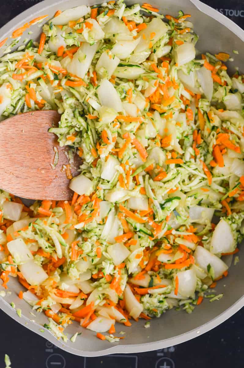 Sauteeing chopped and shredded veggies in a pan.