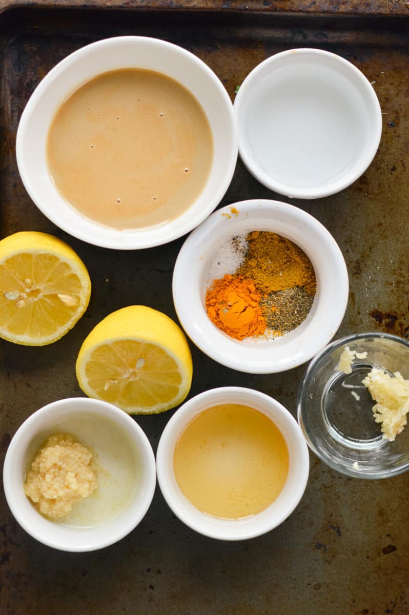 Ingredients including tahini, lemon, honey, water, garlic, spices and ginger.