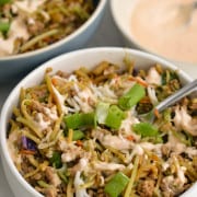 Inside out egg roll bowls served with sriracha mayo sauce.