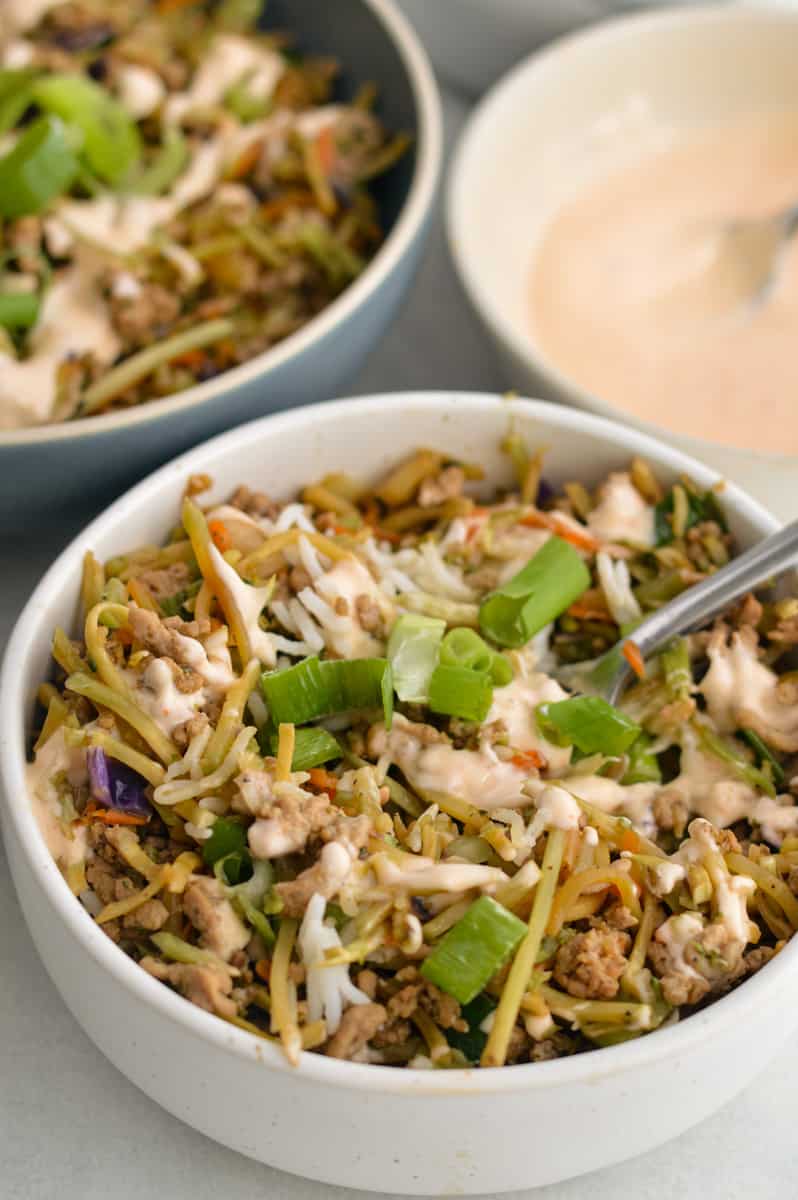 Inside out egg roll bowls served with sriracha mayo sauce.