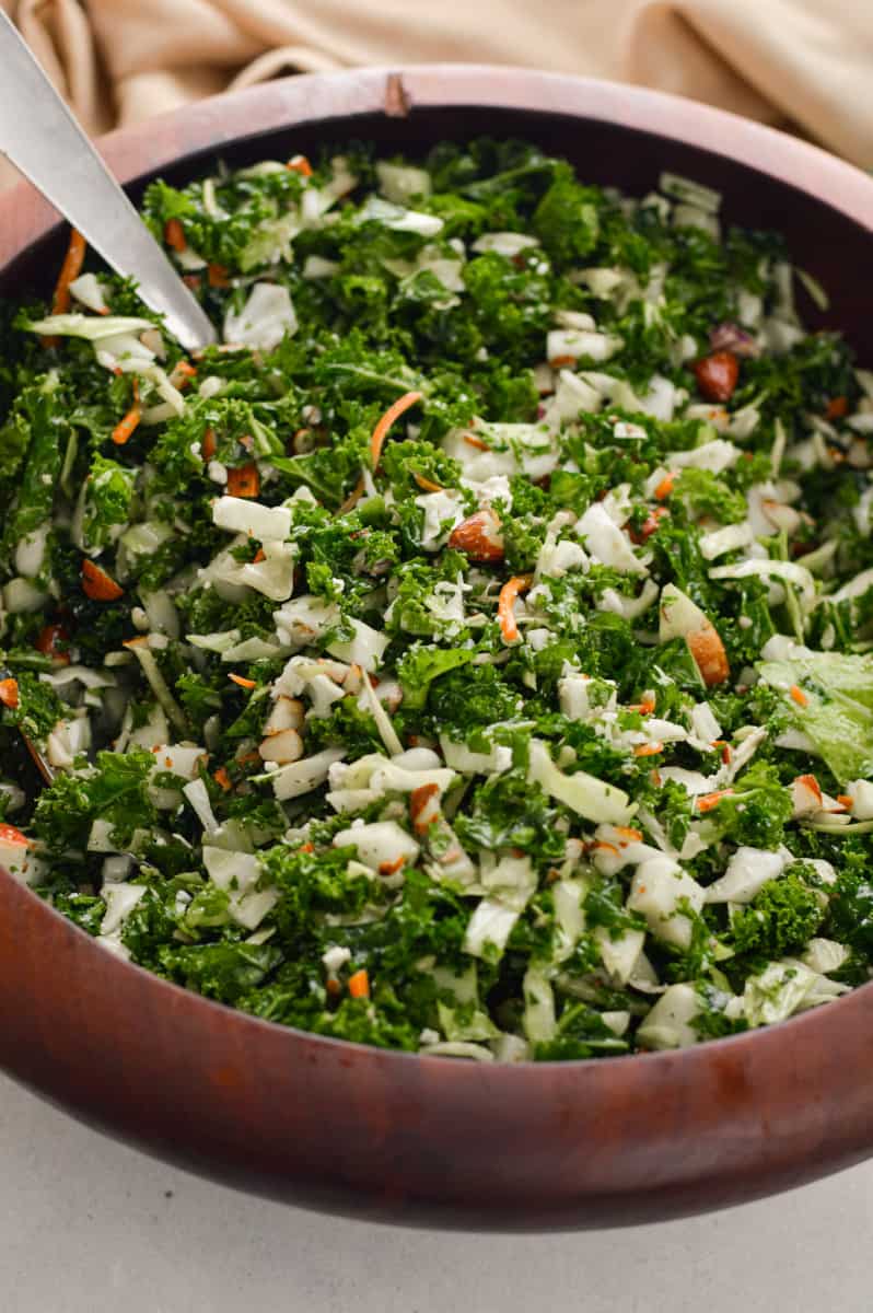 Chick-fil-a kale crunch salad in a wooden serving bowl.
